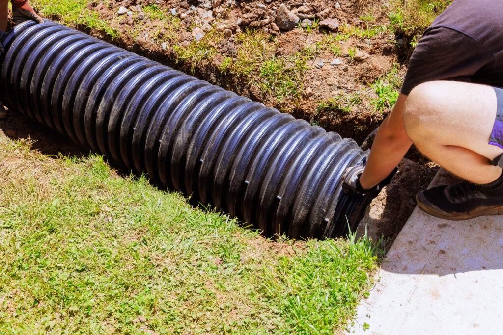 A man showing how to clean a French drain.